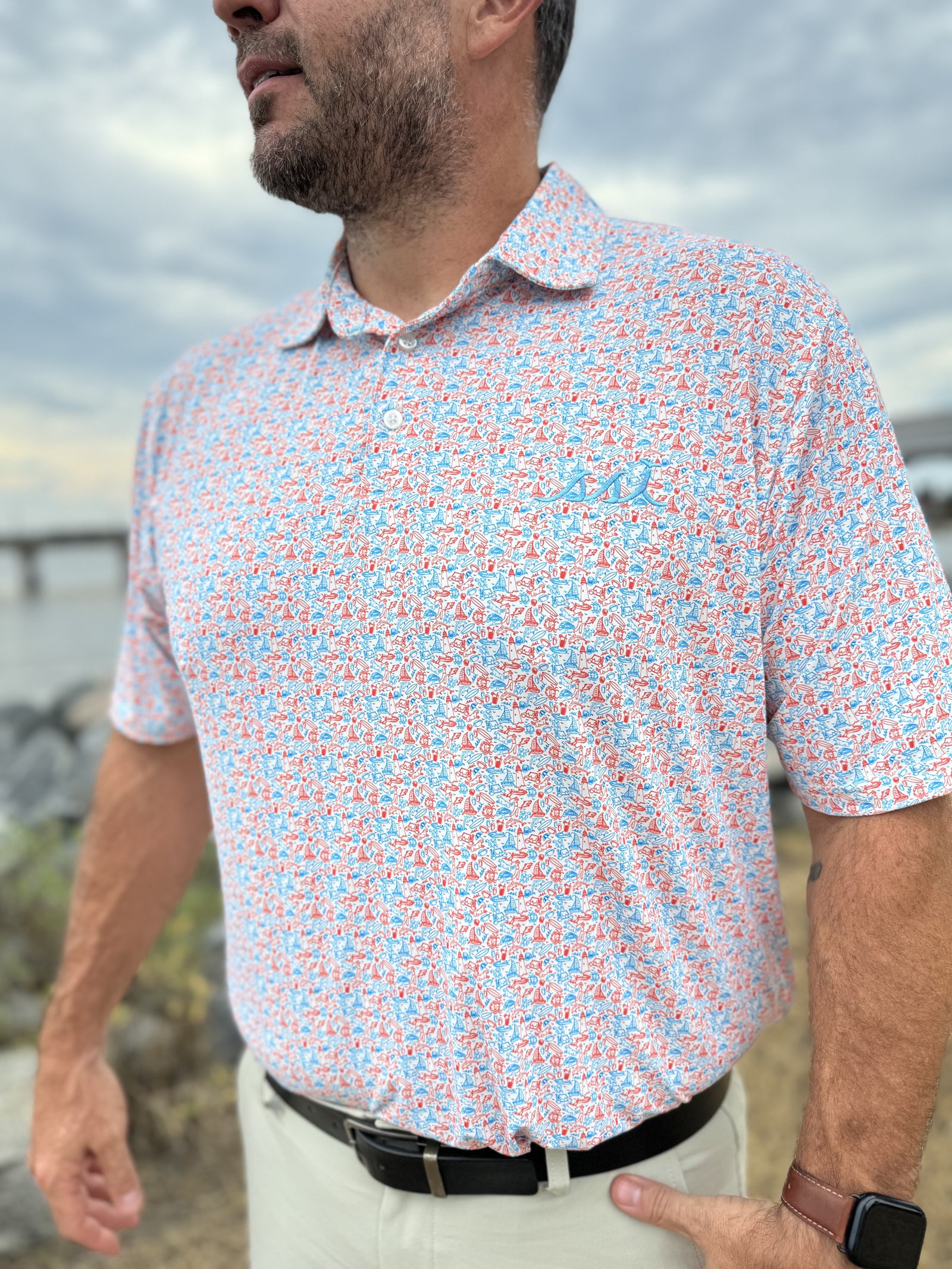 Men's Red and Blue St. Simons Island Icons Allover Print Performance Polo Shirt — Blue SSI Logo